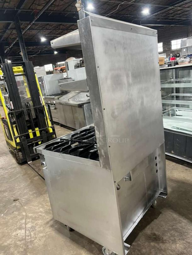 Jade Range commercial gas-powered 4-burner range with full-size oven, raised double shelf backsplash, on casters, stainless steel.