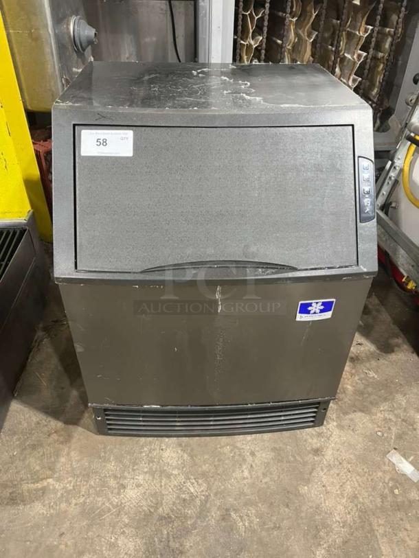 Manitowoc under-counter ice maker, model UYGF0140A-161B, black finish, visible signs of wear, 115V, 1 phase.