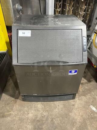 Manitowoc under-counter ice maker, model UYGF0140A-161B, black finish, visible signs of wear, 115V, 1 phase.