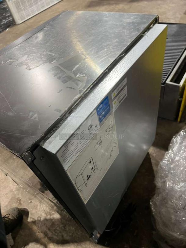 Manitowoc under counter ice maker, model UYGF0140A-161B, 115V, visible labels, used condition with surface wear.