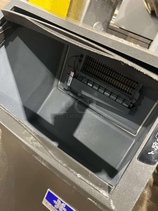 Manitowoc under counter ice maker model UYGF0140A-161B, 115V 1 Phase, in used condition, interior and vents visible.
