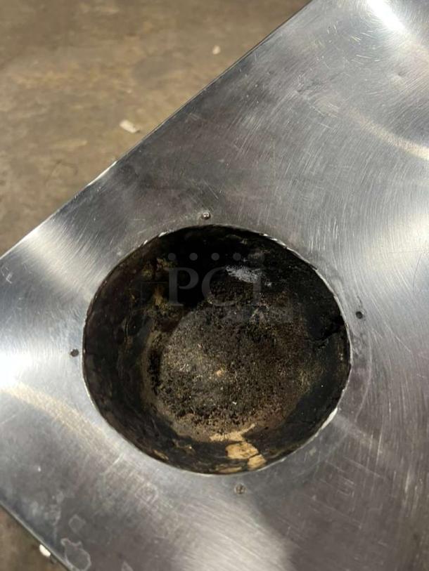 AMCO stainless steel gas-powered Tandoori clay oven, visible top view, with a used clay interior, showing wear.