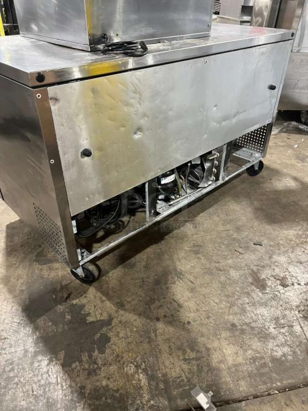 True TUC60 refrigerated 2-door lowboy cooler, 115V, 1 phase. Features under-storage, on casters. Visible surface wear.