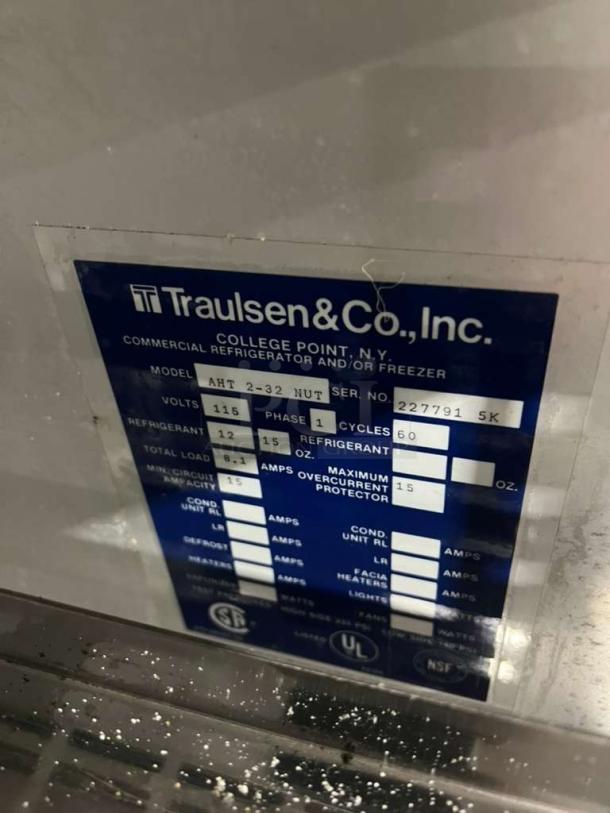 Traulsen AHT2-32 refrigerator label showing model, serial number 227791, 115V, 1 phase. Commercial use details.
