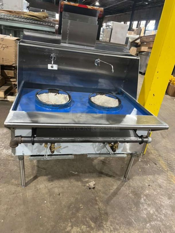 All stainless steel dual wok range with high BTU output, built-in faucets, and legs. In like-new condition.