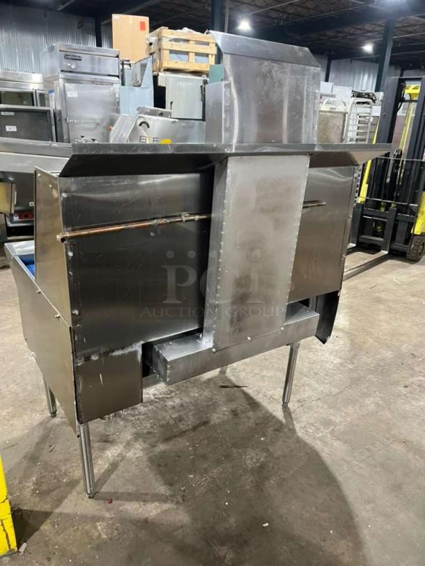 All stainless steel dual wok gas range with high BTU output, built-in faucets, and sturdy legs, like new condition.