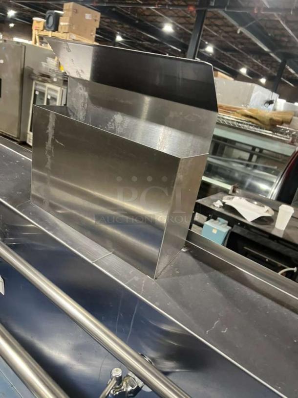 Stainless steel dual wok range with high BTU output, built-in faucets, and sturdy legs. Like new condition.