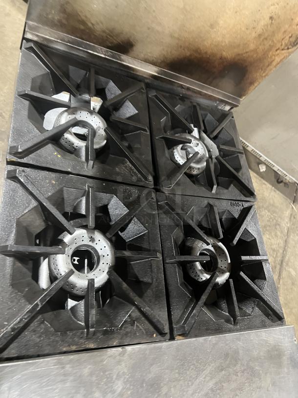 American Range 4-burner gas stainless steel range/oven combo with backsplash, overhead salamander shelf, and wired oven rack.