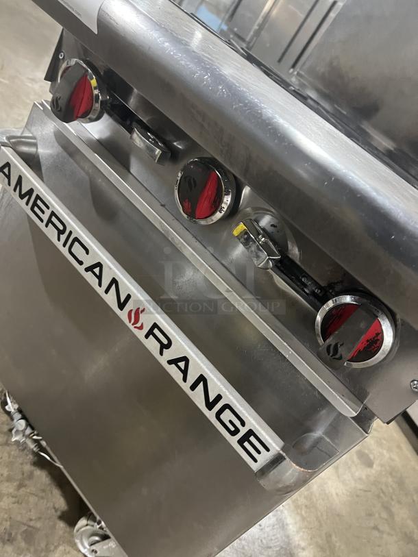 American Range stainless steel 4-burner gas range/oven combo with backsplash and overhead salamander shelf. On casters.