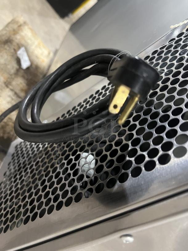 True TBB2448S stainless steel back bar cooler, 2-door model, with black coated wired rack. Power cord visible.