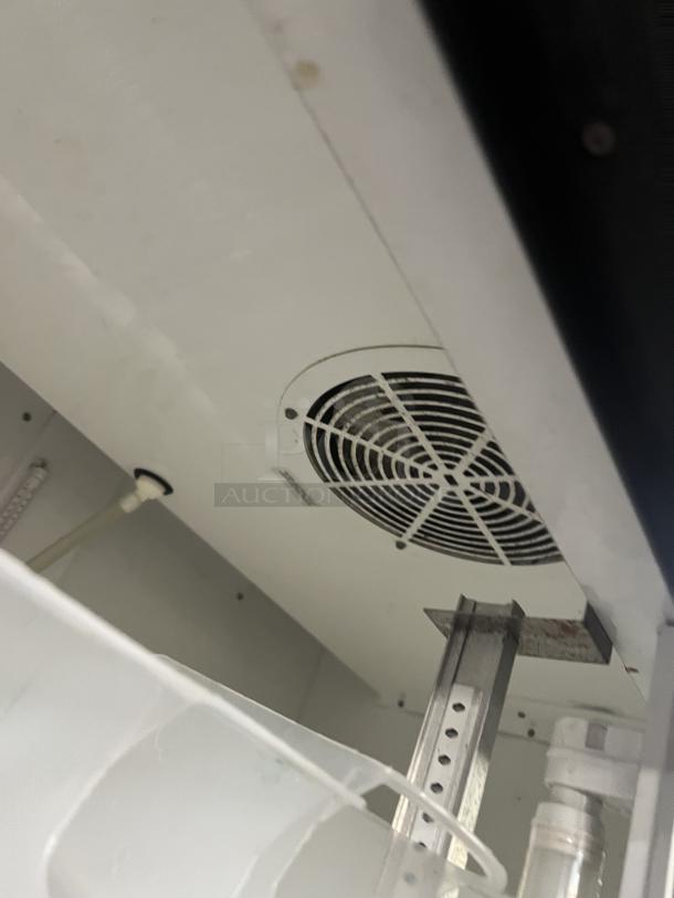 True Commercial Coca-Cola style refrigerator, model GDM-37, with double glass sliding doors, poly coated rack, on casters.