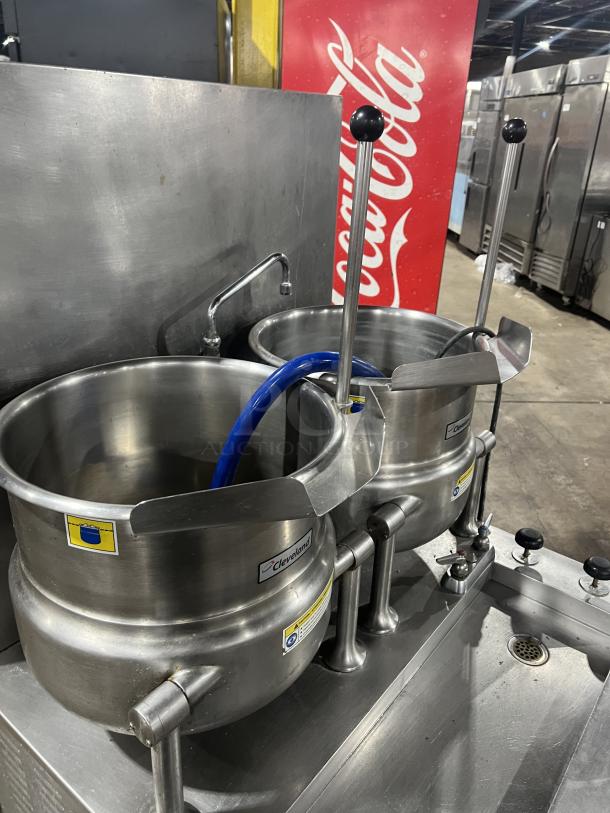 Cleveland Range stainless steel 10-gallon tilting steam jacketed kettles, Model 36GMK1010300, with modular generator base and blue hose.