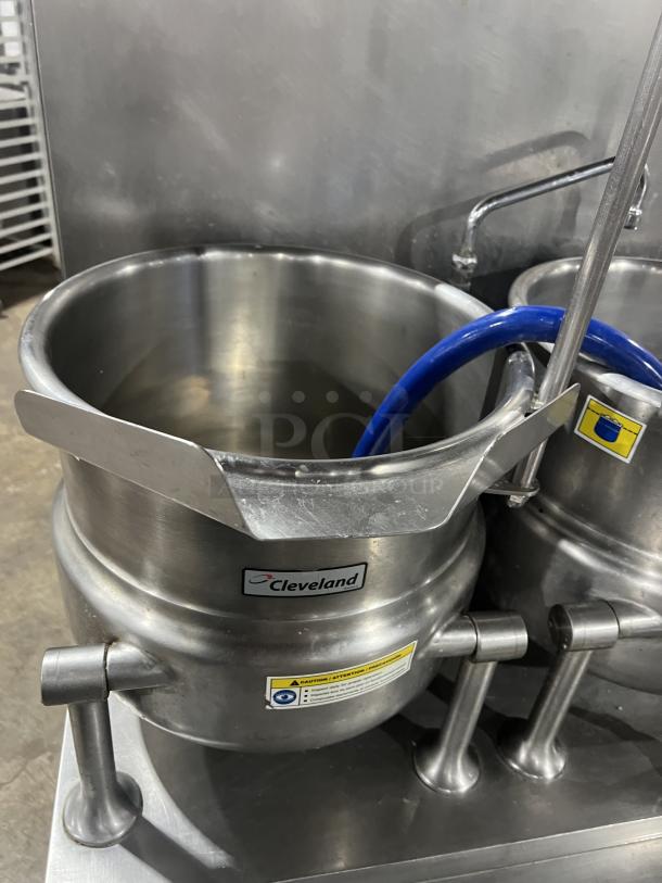 Cleveland Range stainless steel 10-gallon steam jacketed tilting kettles, model 36GMK1010300, on legs, with labels.
