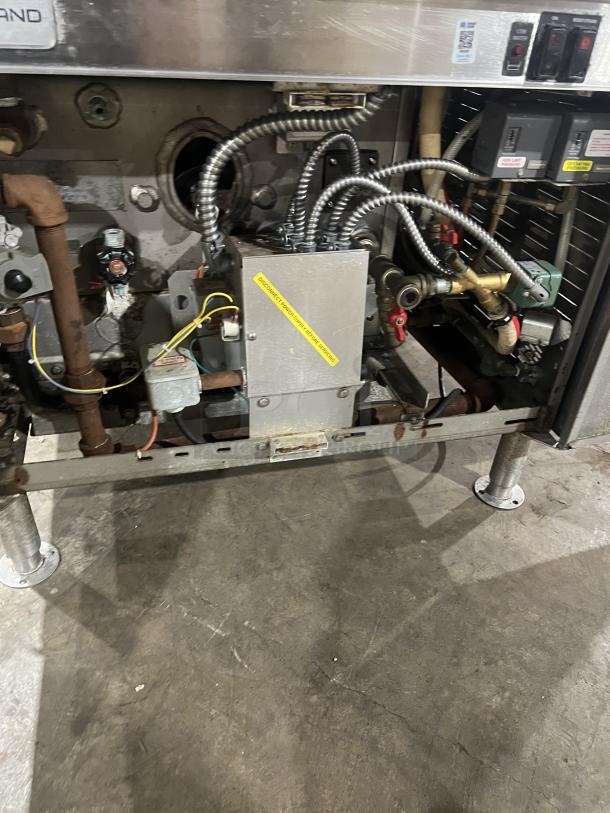 Cleveland Range stainless steel tilting kettles, Model 36GMK1010300, with modular generator base, 115V, on legs.