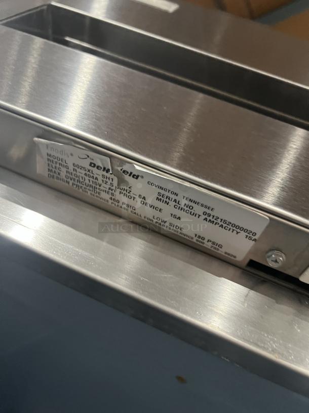 Delfield commercial stainless steel half-door reach-in refrigerator. Includes wired rack, serial number 0912152000020, on casters.