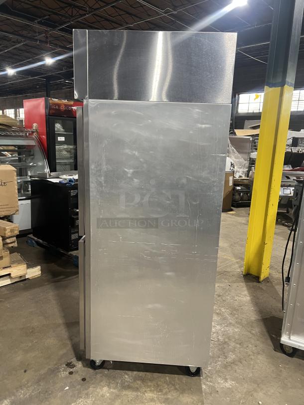 Delfield commercial stainless steel half-door refrigerator on casters with wired rack, SN: 0912152000020, shown in warehouse.