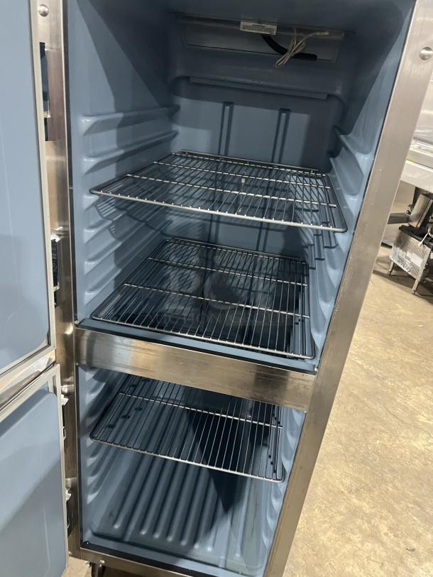 Delfield stainless steel half-door single section reach-in refrigerator with wired rack, SN: 0912152000020, on casters.