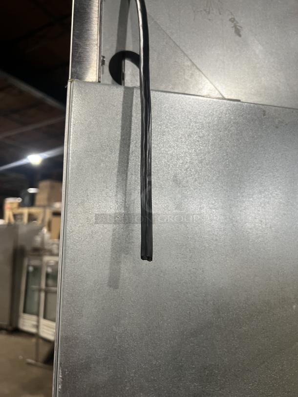 Delfield stainless steel reach-in refrigerator, half-door, single section, on casters, features wired rack, SN: 0912152000020.