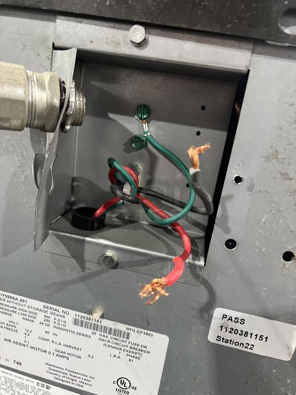 Manitowoc stainless steel ice machine model IY0906A-261. Shows wiring, serial number 1120381151, and label details.