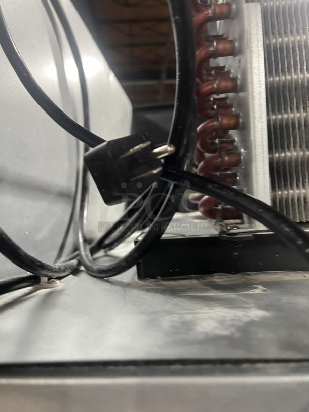 Everest ESR1 commercial stainless steel refrigerator, 115V, single solid door, poly coated rack, on casters, wiring visible.