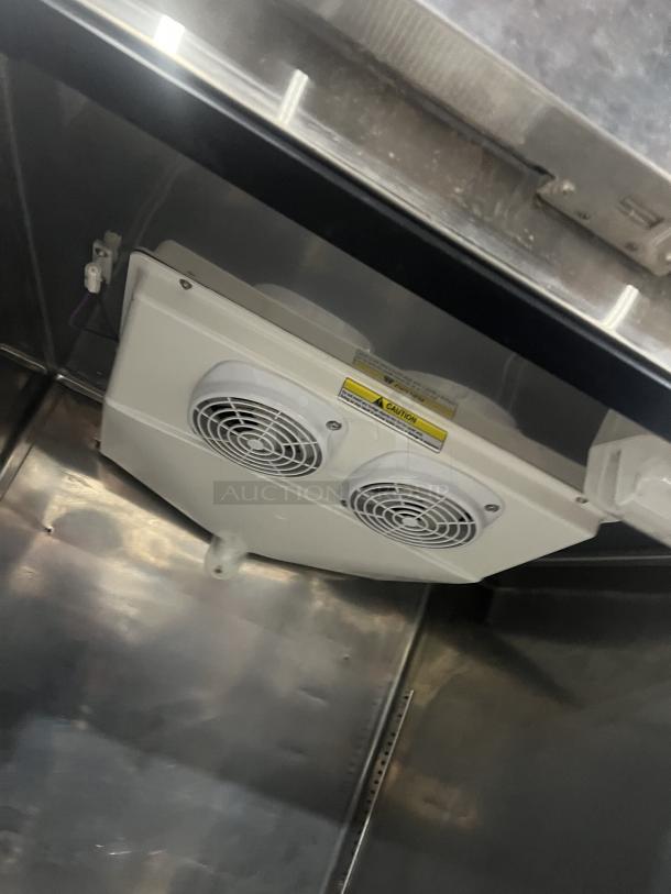 Everest ESR1 stainless steel refrigerator interior with cooling system, poly coated wire rack, and caution label, on casters.