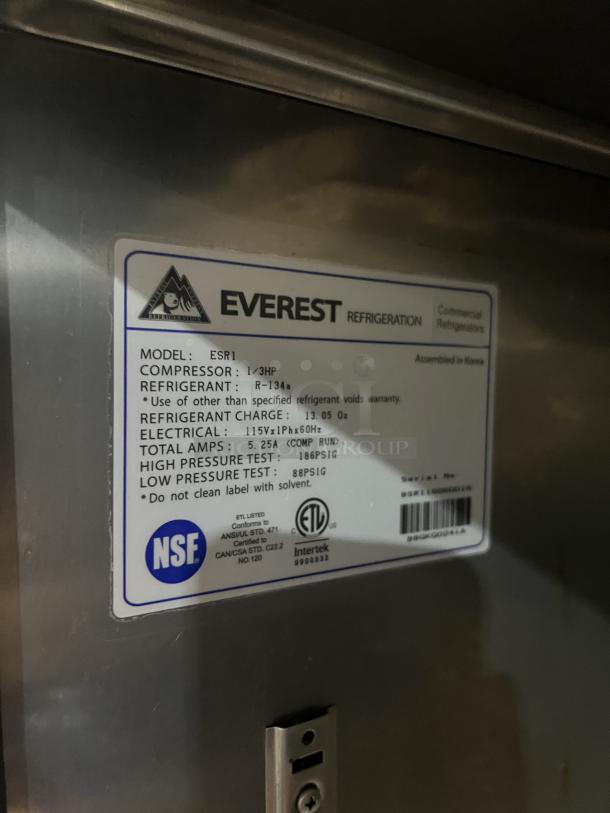 Everest ESR1 stainless steel refrigerator tag, showing model, compressor info, refrigerant type, and certification labels.