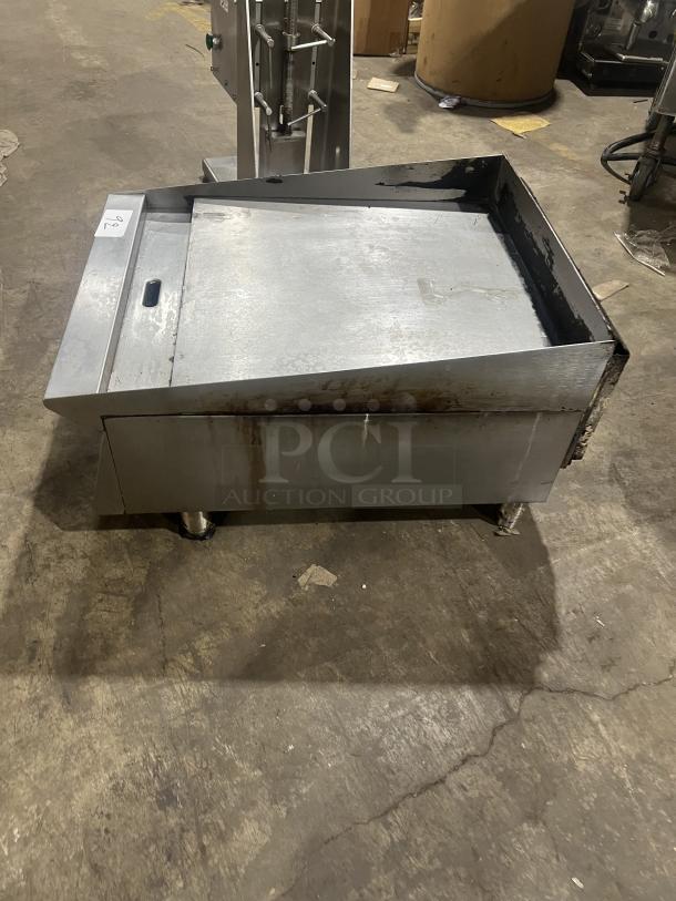 Commercial stainless steel gas-powered countertop flat griddle with back and side splash, on legs, used condition.