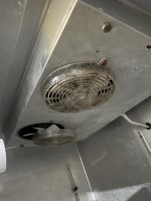 Continental 2R stainless steel 2-door reach-in refrigerator interior view, model and serial number visible, on casters.