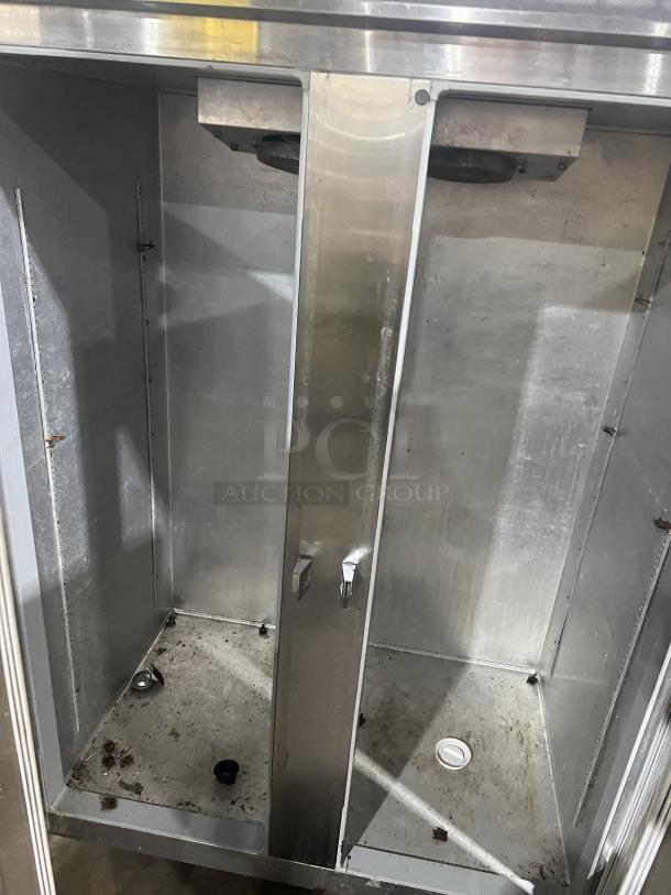 Continental Commercial Stainless Steel 2-Door Refrigerator, Model 2R. Interior view shows wear. On casters, 115V, 1 phase.