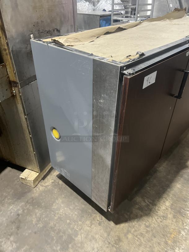Perlick stainless steel 3-door bar back cooler, Model C5064ESCUL, with wired rack. Visible paper wrapping, minor wear.