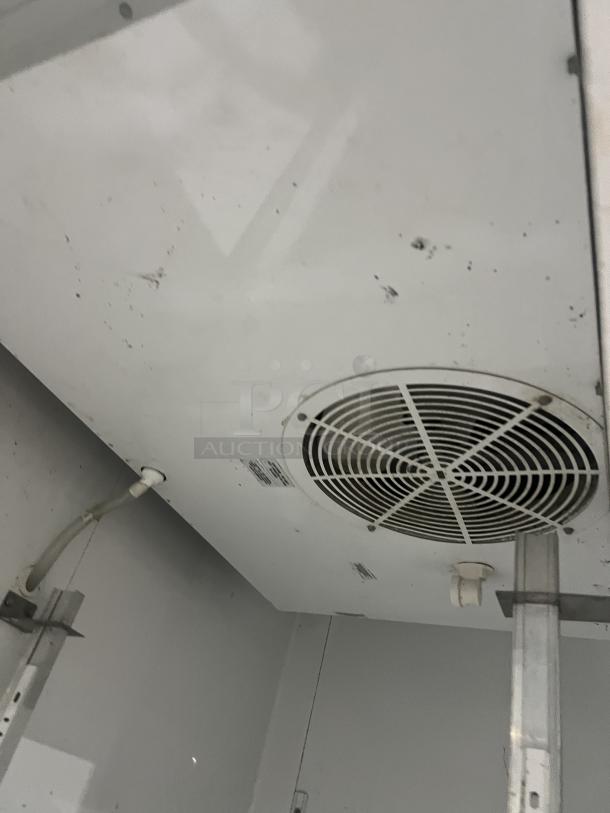 Interior view of True T-49 2-door refrigerator showing fan and internal components. Model T-49, SN: 6526031, 115V, 1 phase.