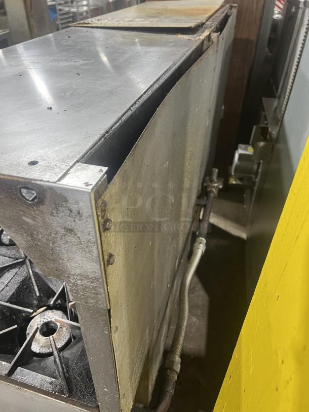 Vulcan 8-burner range with flat griddle, double oven, backsplash, and salamander shelf. Model 72SS-2-24G8B. Good condition.