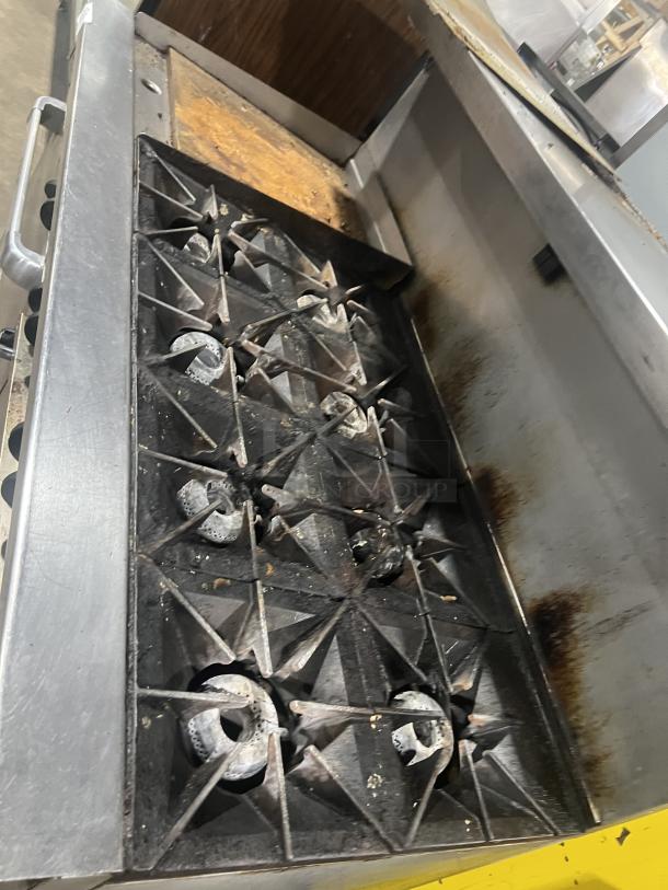 Vulcan 8-burner range with split top griddle, double oven, backsplash, and salamander shelf. Model: 72SS-2-24G8B. Used condition.