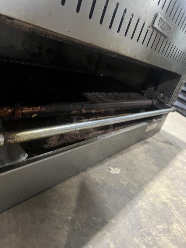 Commercial stainless steel gas salamander broiler in used condition, features adjustable grill, and visible branding label.