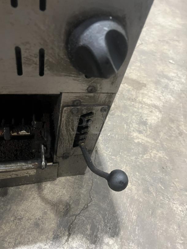 Commercial stainless steel gas salamander broiler in used condition, featuring adjustable knob and lever control.