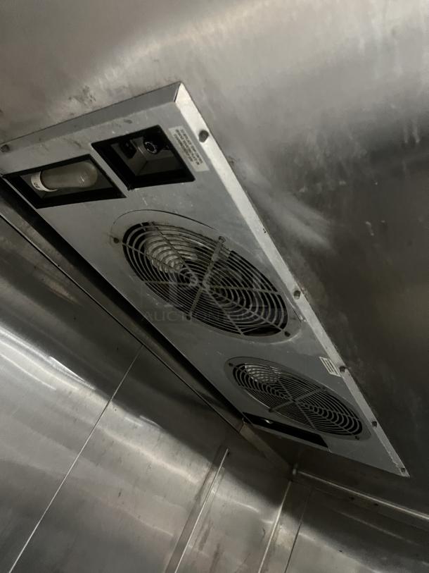 True commercial 2-door refrigerator interior view showing ventilation fans and stainless steel finish. Model TR2RRI-2S.