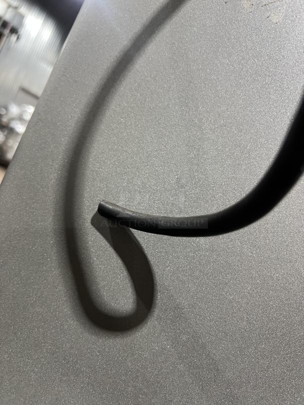 Univex SRM60+ mixer cord against a textured gray background, detail view.