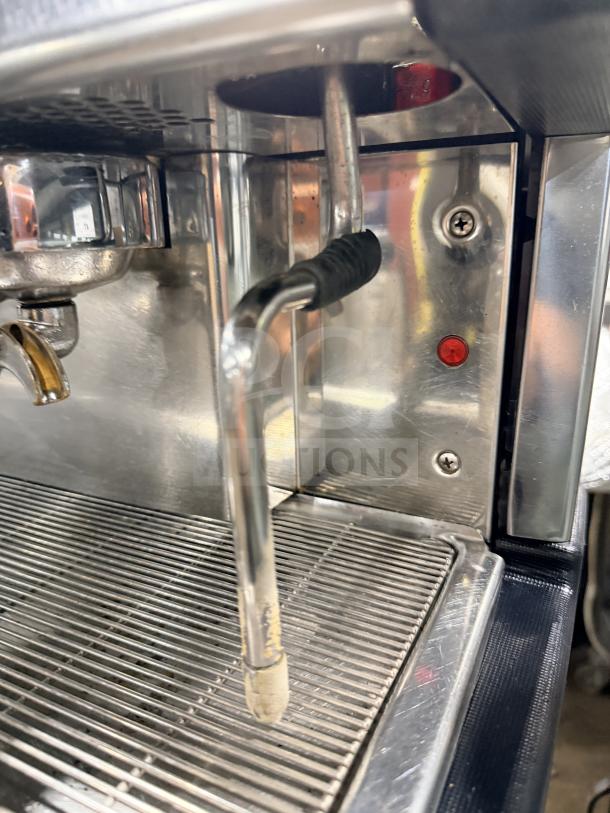 Danesi stainless steel commercial espresso machine, 3-group, robust condition, with steam wand, visible buttons, and drip tray.