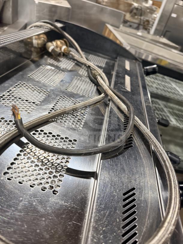 Danesi commercial stainless steel countertop 3-group espresso coffee machine, visible hoses and wiring, moderate condition.