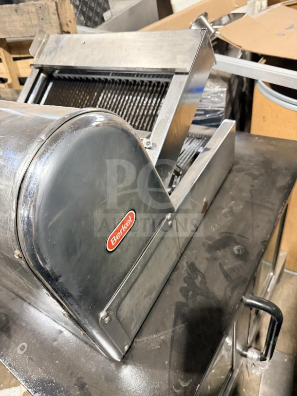Berkel commercial stainless steel countertop bread slicer in good condition, featuring visible brand logo on side panel.