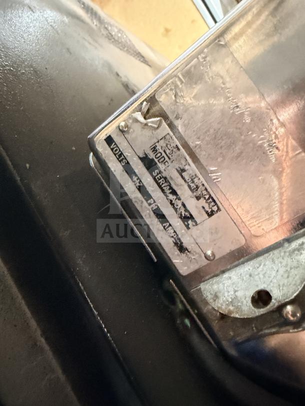 Berkel commercial stainless steel bread slicer, showing worn label with power specifications. Used condition.