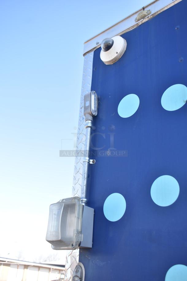 2019 Quality Cargo 8.5' x 24' kitchen trailer, Burger King spec, exterior view, includes surveillance camera and weatherproof electrical outlet.