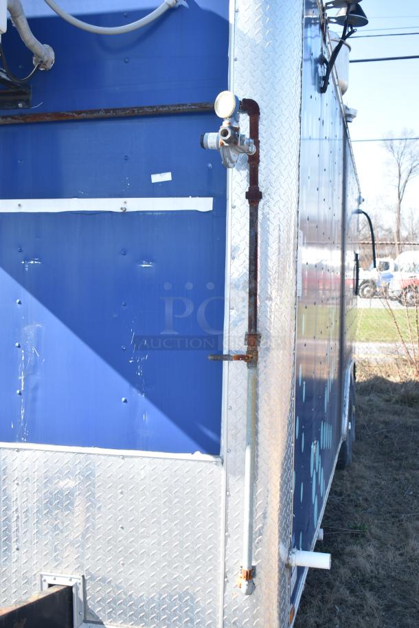 2019 Quality Cargo 8.5' x 24' mobile kitchen trailer with grease hood, refrigeration, fryers, and griddle. Visible exterior wear.