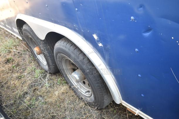 2019 Quality Cargo 8.5' x 24' mobile kitchen trailer side view, blue exterior, visible tire, and some cosmetic dents.