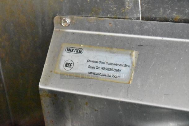Stainless steel compartment sink with MixRite and NSF labels, part of a mobile kitchen trailer.