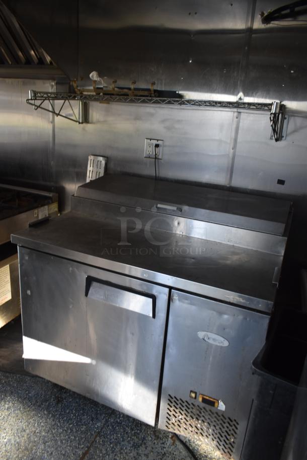 2019 Quality Cargo 8.5' x 24' mobile kitchen trailer interior showing stainless steel refrigeration unit and prep area.