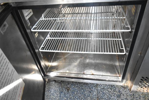 2019 Quality Cargo mobile kitchen trailer refrigeration unit, featuring shelves and visible interior wear. VIN: 50ZZ1E426KN012862.