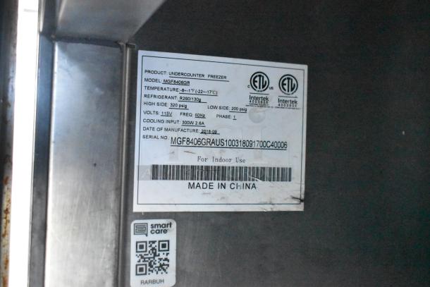 Label on Burger King mobile kitchen trailer showing freezer specs: Model MGF8406GR, uses R290 refrigerant, 115V, 2018 made.