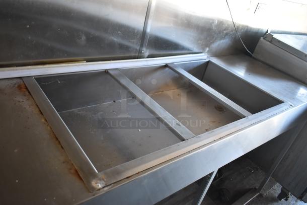 2019 mobile kitchen trailer with metal countertop interior, showing signs of use and ready for outfitting.