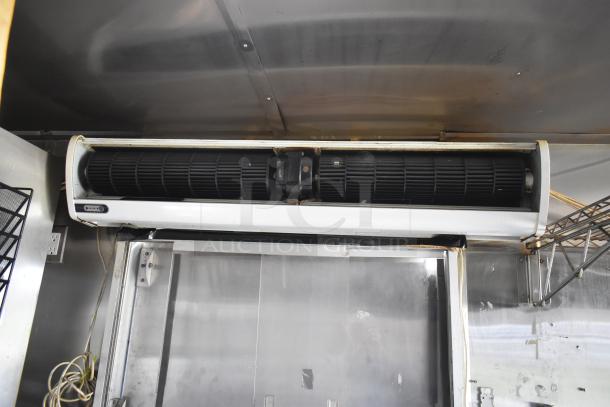 Interior view of 2019 Quality Cargo mobile kitchen trailer showing air conditioning unit and metal shelving.